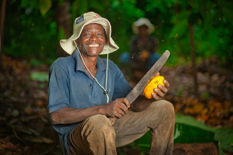 Cocoa farmer on the field. Photo by Charles William Adofo @ Unsplash