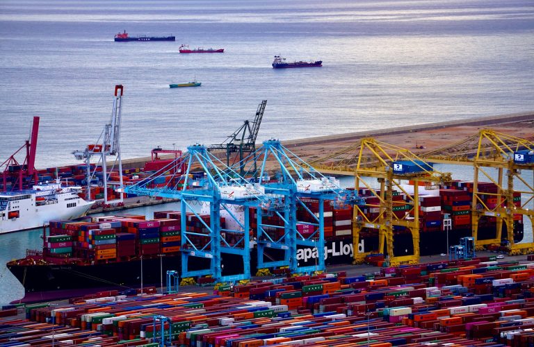 Loading of maritime containers aboard vessels in a seaport. Photo @ Unsplash