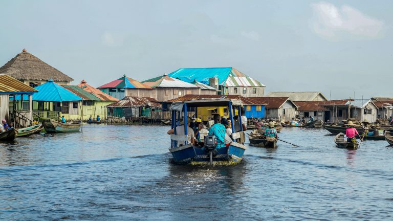 People traveling in a canoe in Ganvie, Benin. Photo @ Unsplash