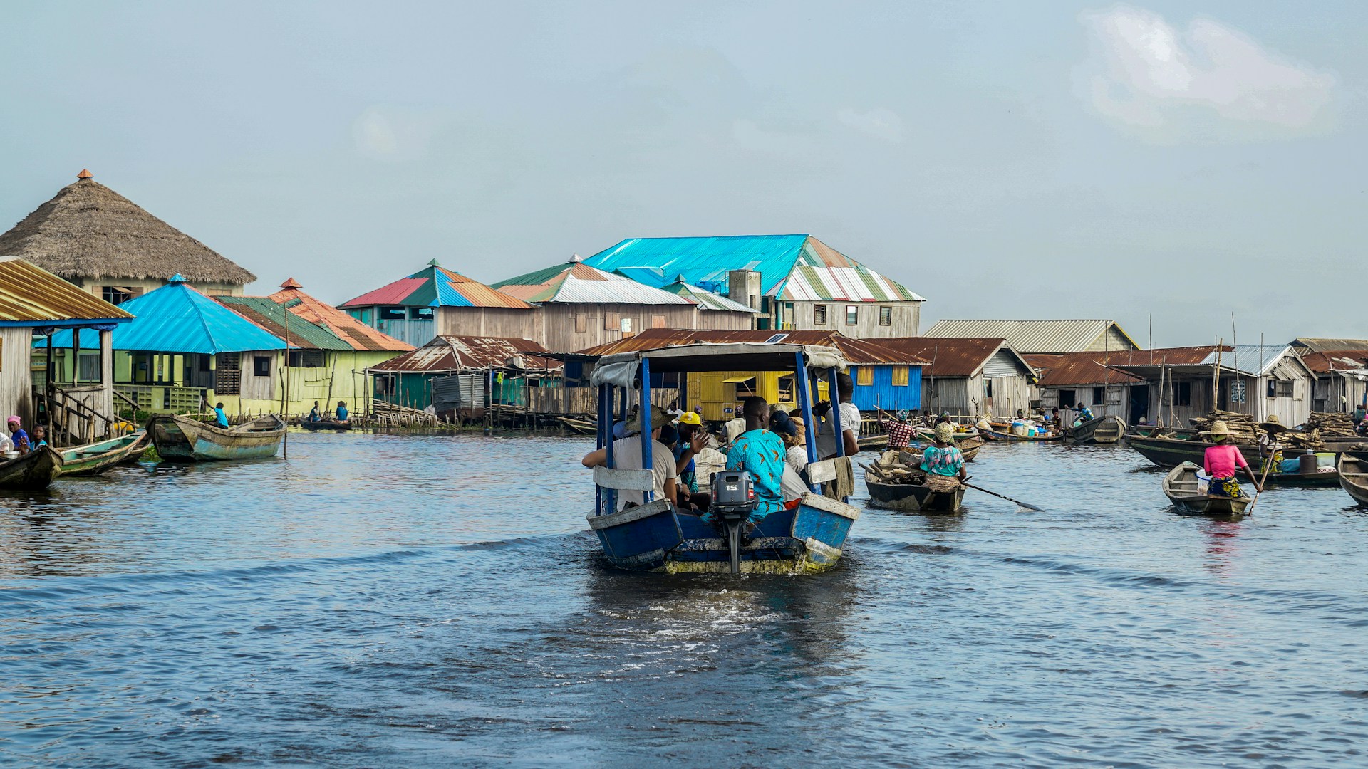 People traveling in a canoe in Ganvie, Benin. Photo @ Unsplash