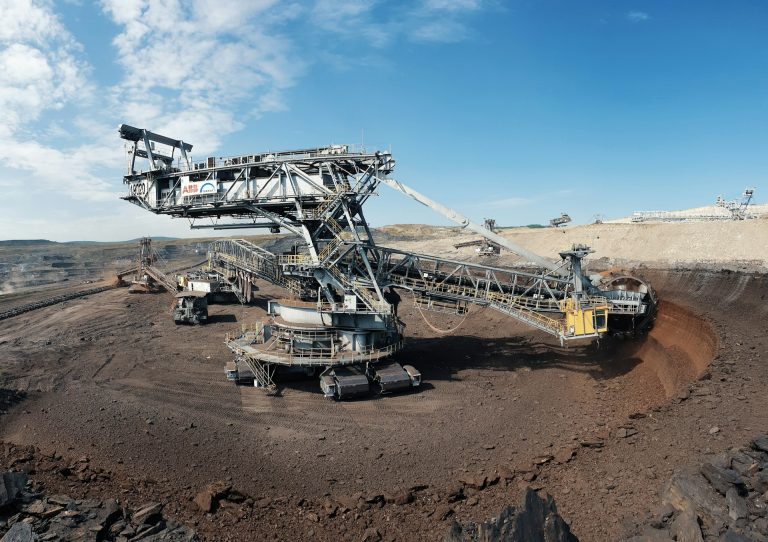 Gold mining machine, excavator. Photo by Albert Hyseni @ Unsplash