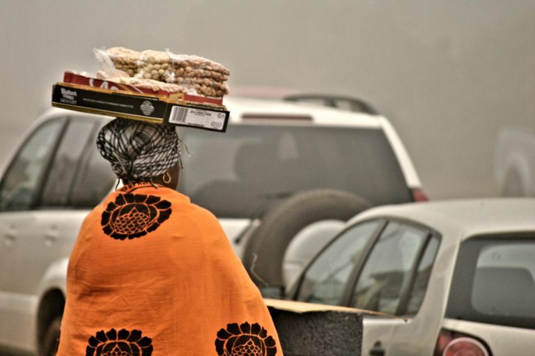 Elderly woman on a busy street. Photo by Ink Pond @ Unsplash