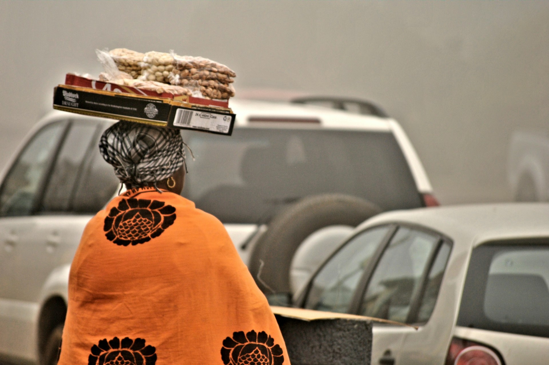 Elderly woman on a busy street. Photo by Ink Pond @ Unsplash