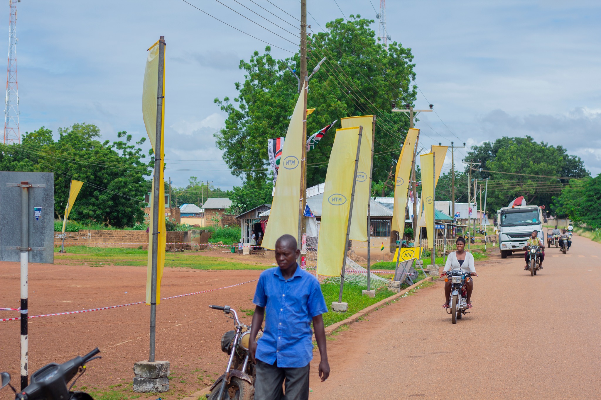 Man walks pass MTN Ghana street flags. Photo @ MTN Ghana/Facebook