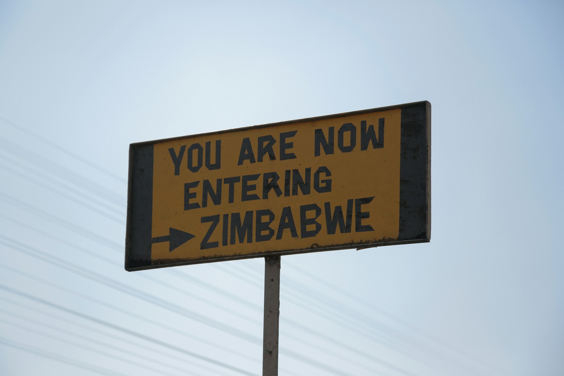 Road signage giving directions to Zimbabwe. Photo by Chloe Evans @ Unsplash