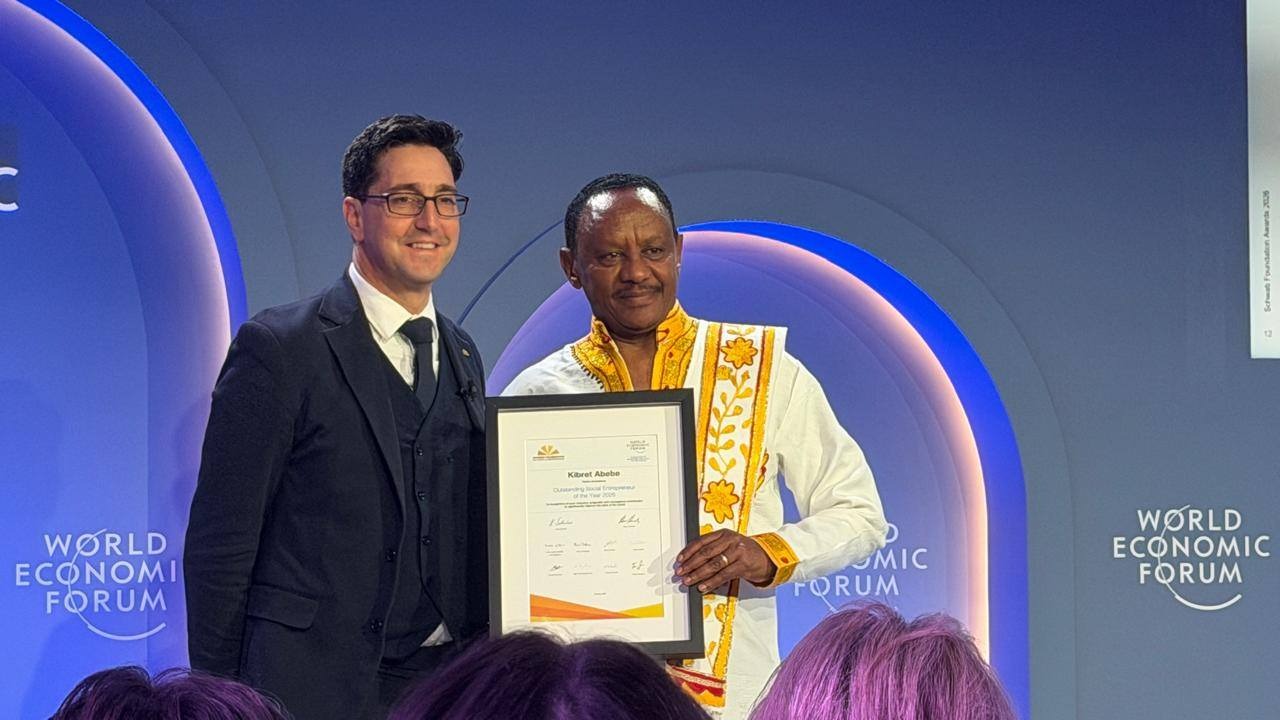 Kibret Abebe, CEO of Tebita Ambulance (r) being recognised in Davos