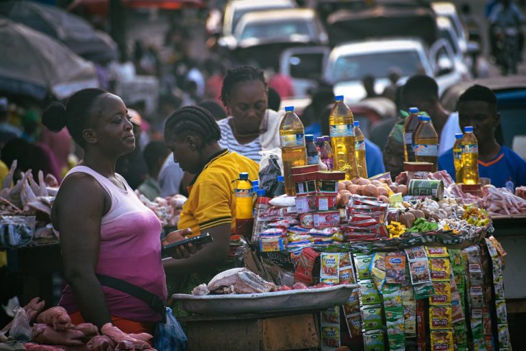 A woman selling in the market. Photo by B. Aristotlè Guweh Jr @Pexels
