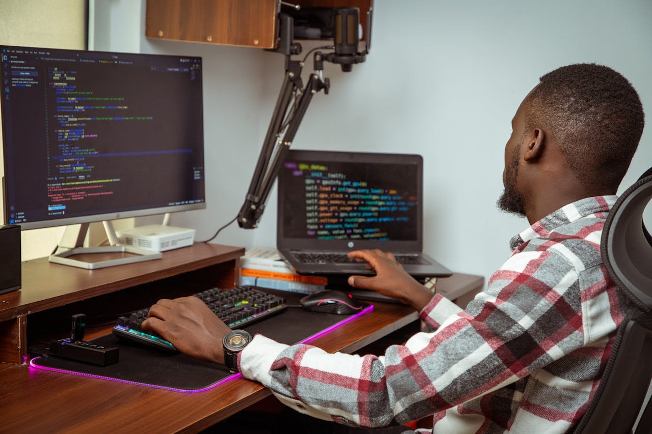 A young African tech enthusiast at work. Photo by Naboth Otieno @Pexels.