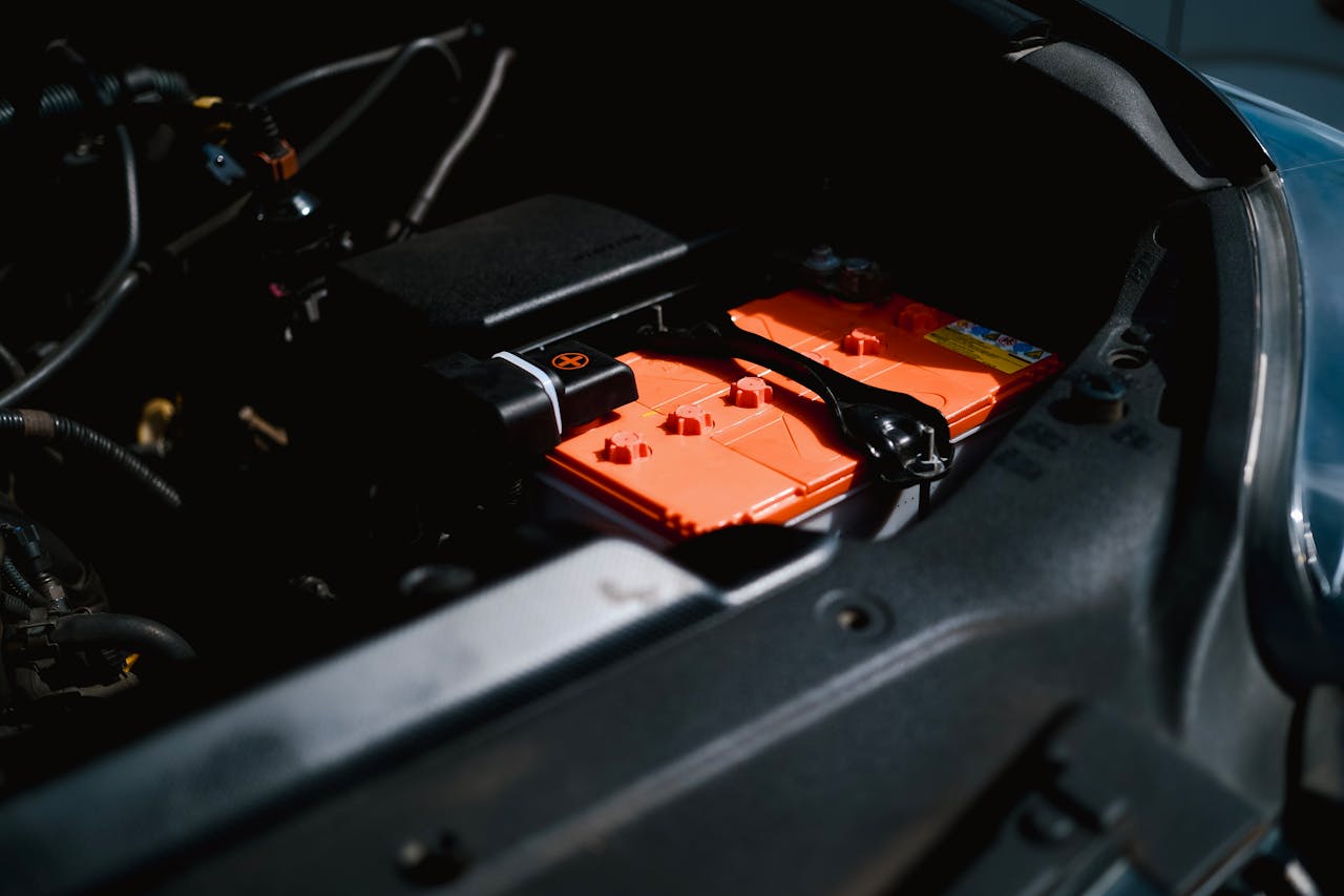An electric car battery made from lithium inside a vehicle's engine compartment. Photo by Ayyeee Ayyeee @ Pexels