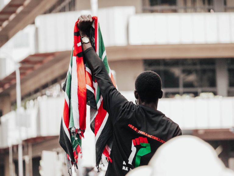 A protester holding the Kenyan flag during a demonstration in Nairobi's streets. Photo: @Pexels