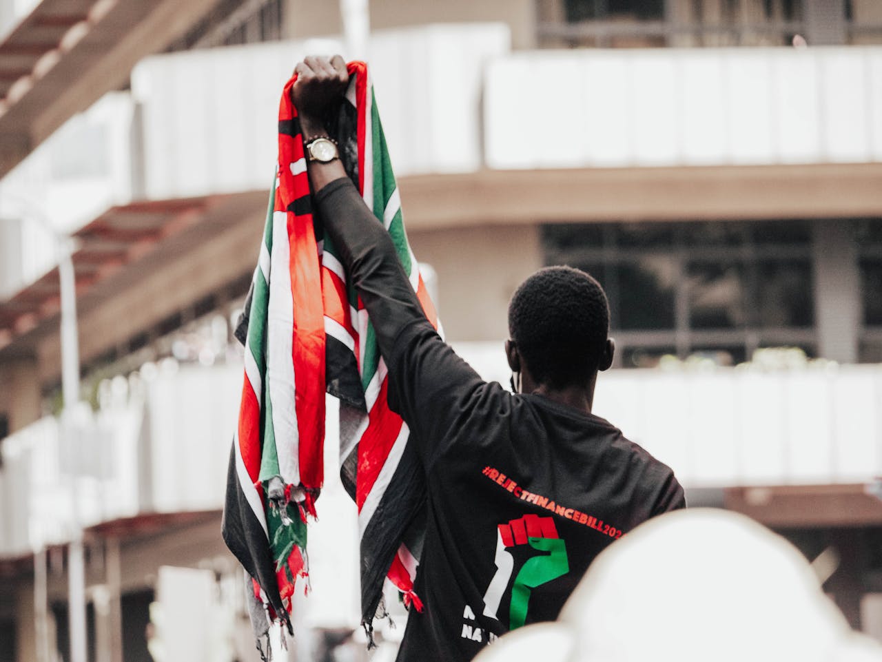 A protester holding the Kenyan flag during a demonstration in Nairobi's streets. Photo: @Pexels