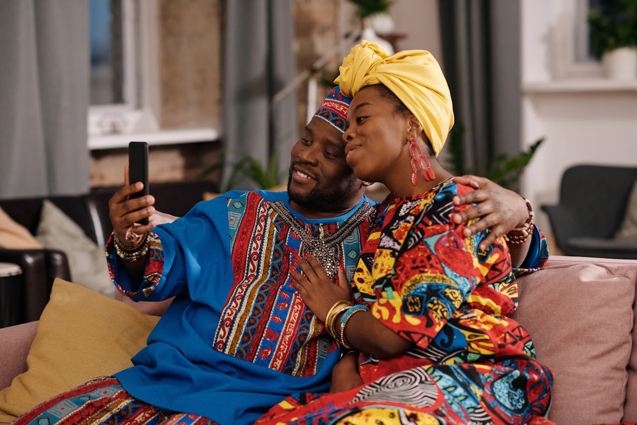 A joyful couple streaming movie on phone. Photo by Askar Abayev @Pexels