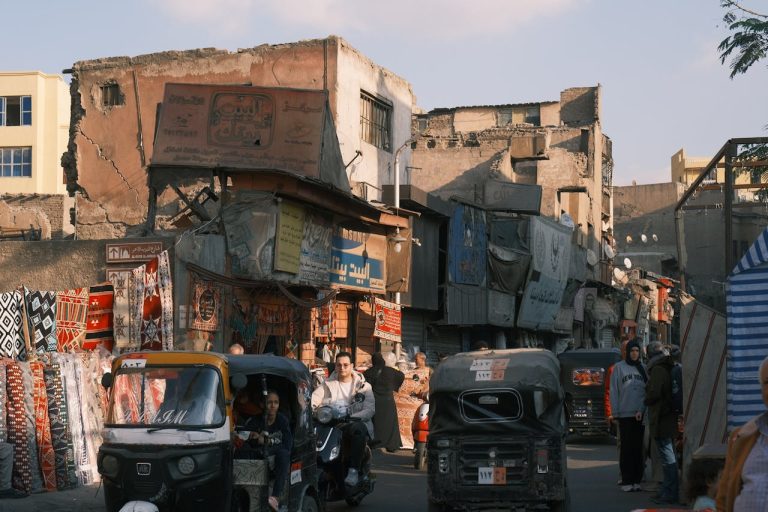 Vibrant street market scene with tuk-tuks in Egypt. Photo by Tito Zzzz @ Pexels