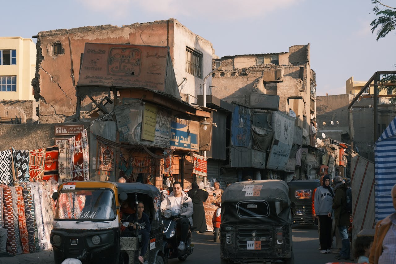 Vibrant street market scene with tuk-tuks in Egypt. Photo by Tito Zzzz @ Pexels