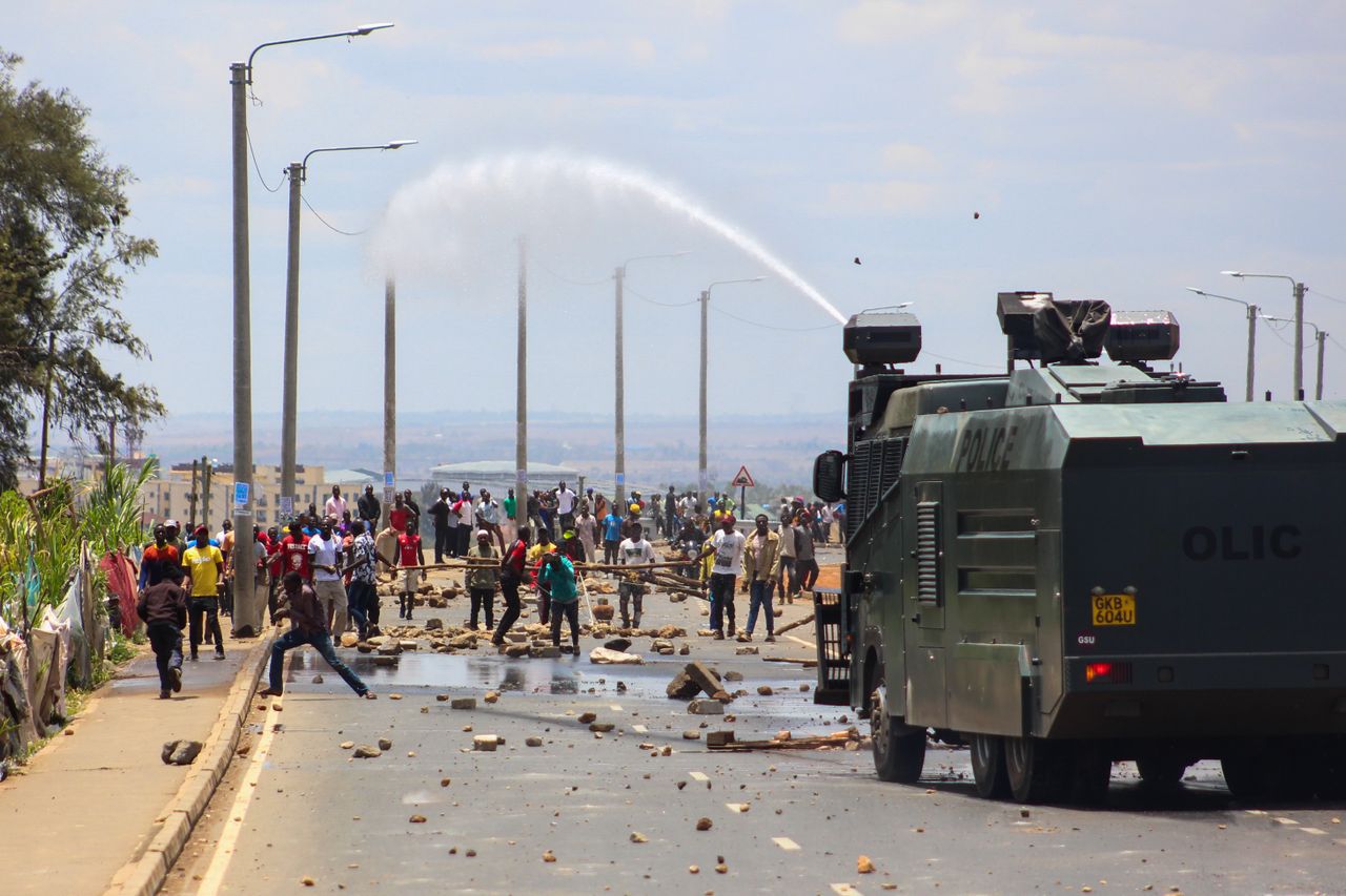 A tense protest scene in Nairobi, Kenya with a military vehicle using a water cannon against demonstrators. Photo by Stasham @ Pexels