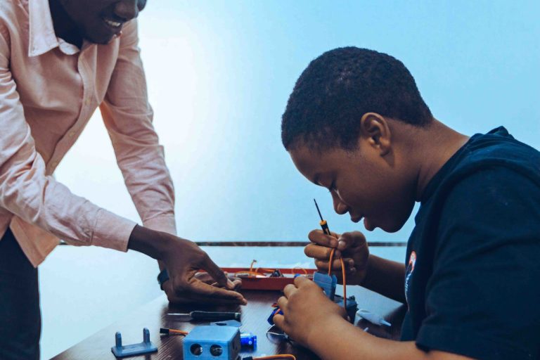A student and a teacher engage in practical electronics learning in a classroom environment. Photo by Zeal Creative Studios @Pexels