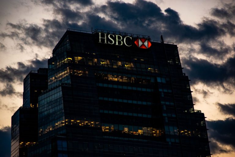 An illuminated HSBC office building. Photo by Franco Monsalvo @ Pexels