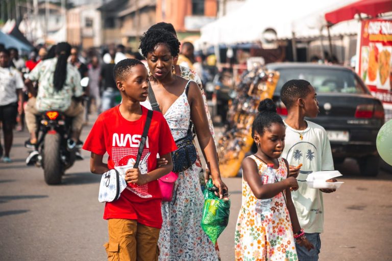 A family day out in a bustling street market in Accra, Ghana. Photo by Michael Quaynor @ Pexel