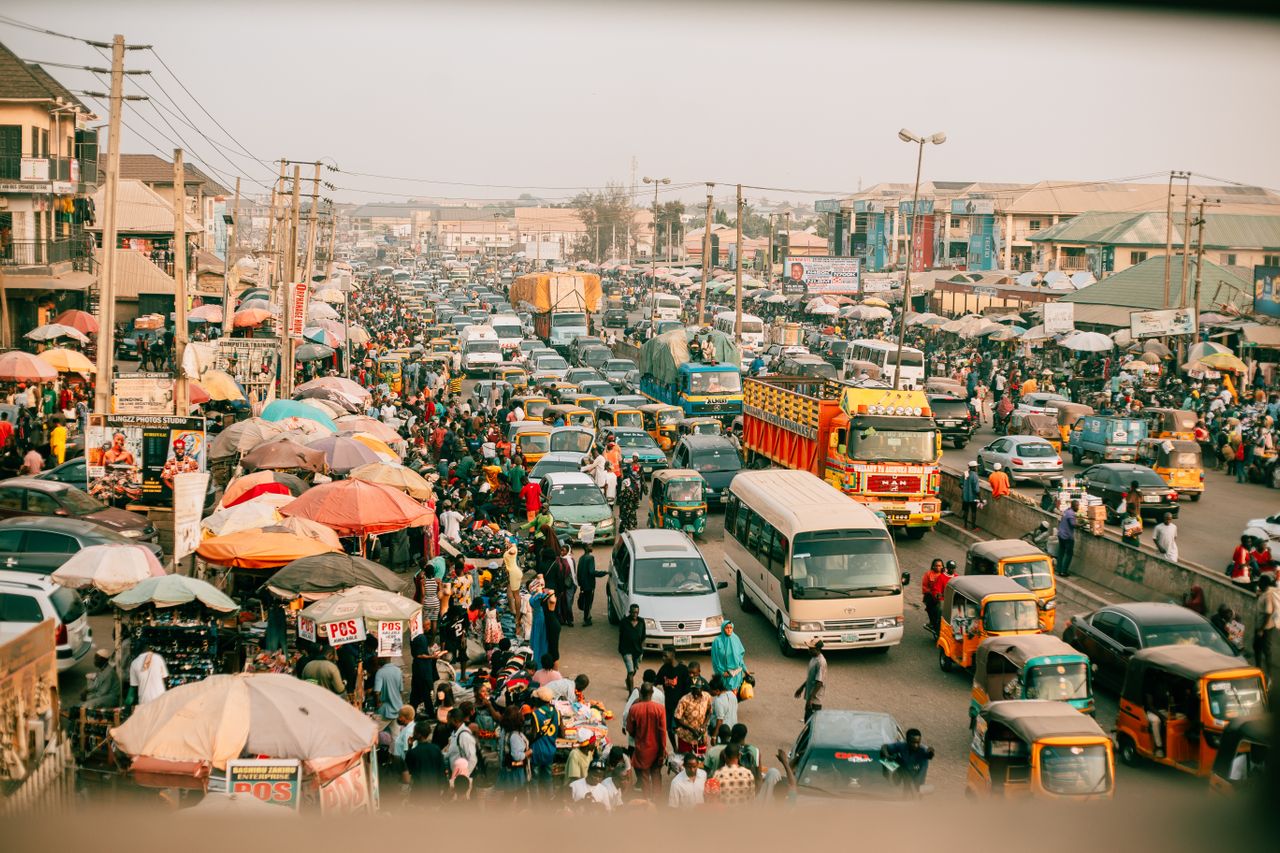 A lively street market with busy traffic. Photo by Meshack Emmanuel Kazanshyi @ Pexels