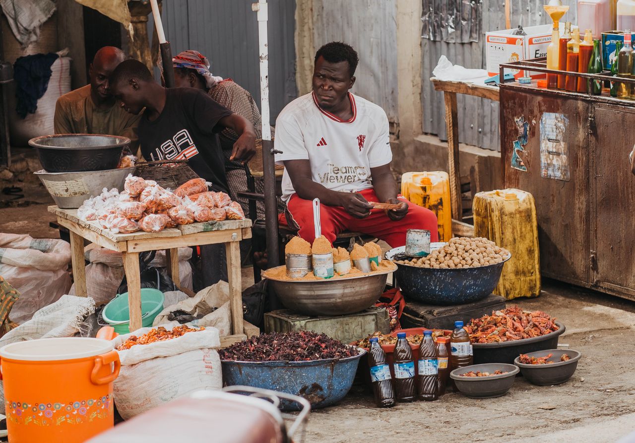 A bustling African market with vendors selling spices. Photo by Darkside Photography @ Pexels