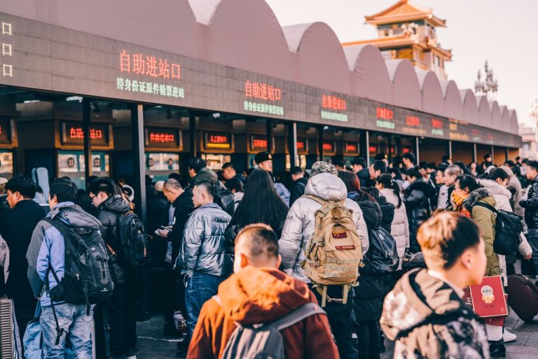 A crowd of people waiting in line at a ticket station in Beijing, China, Photo by Zhang Kaiyv @ Pexels